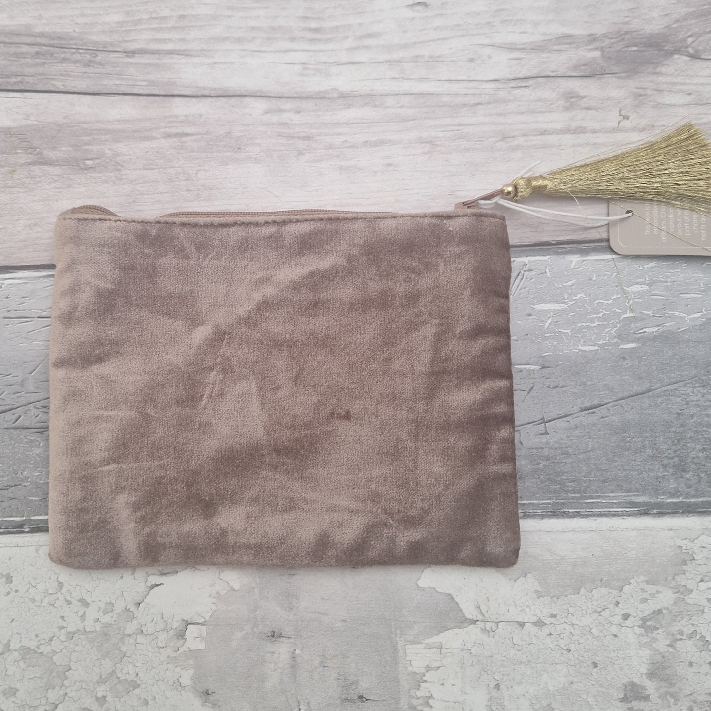 Rear view of a buff coloured velvet pouch.