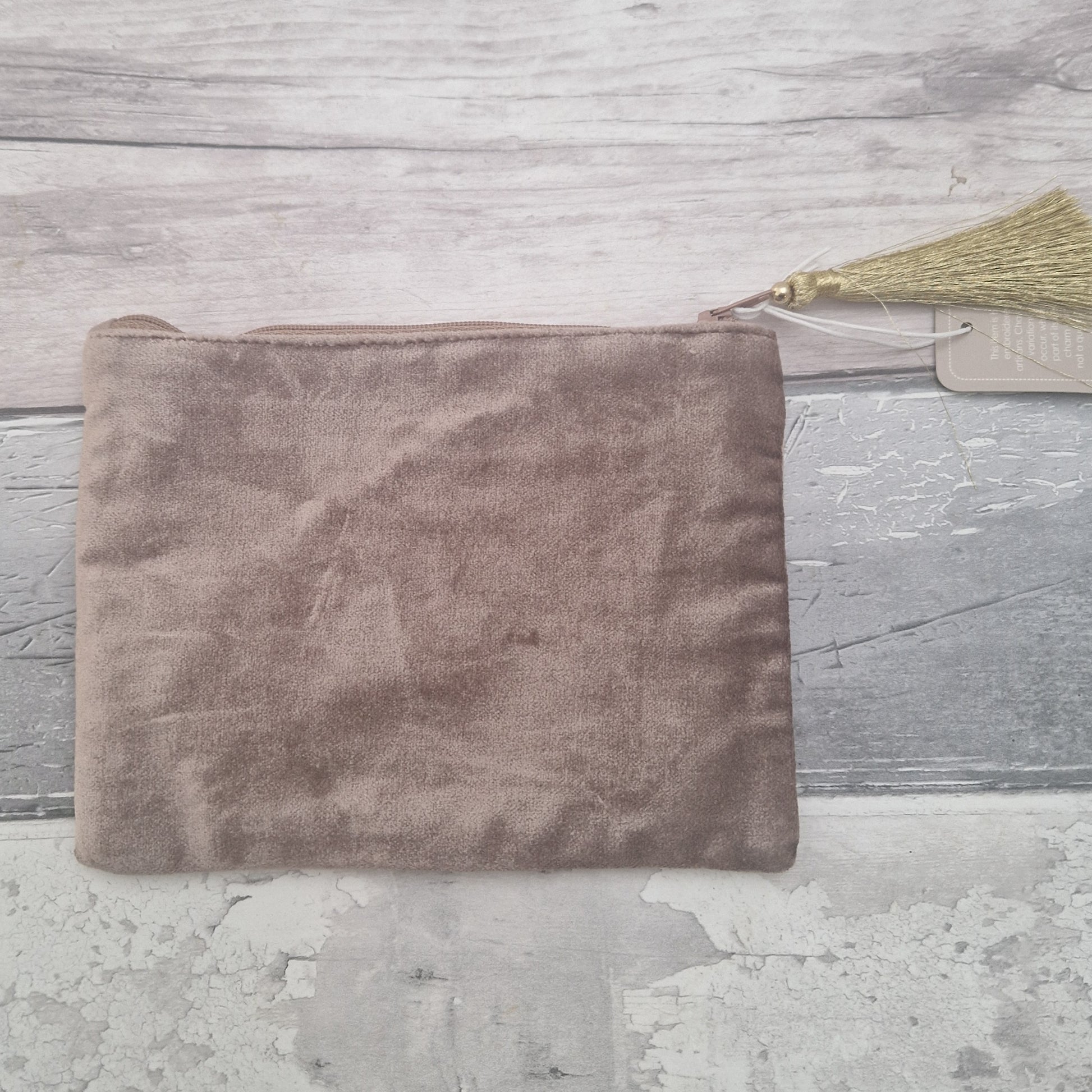 Rear view of a buff coloured velvet pouch.