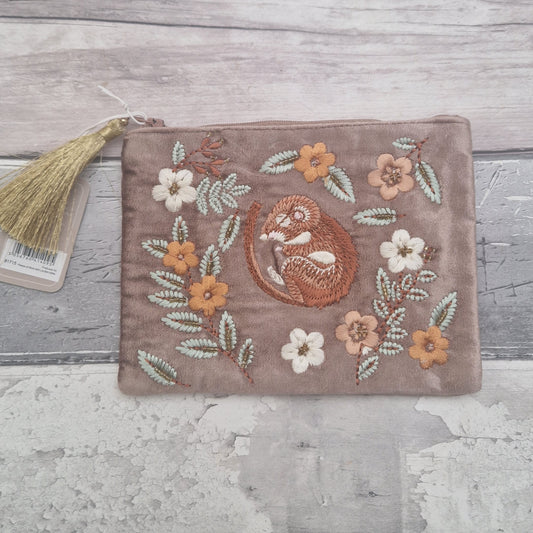 Buff velvet coloured pouch decorated with an embroidered image of a sleeping dormouse surrounded by leaves and flowers.