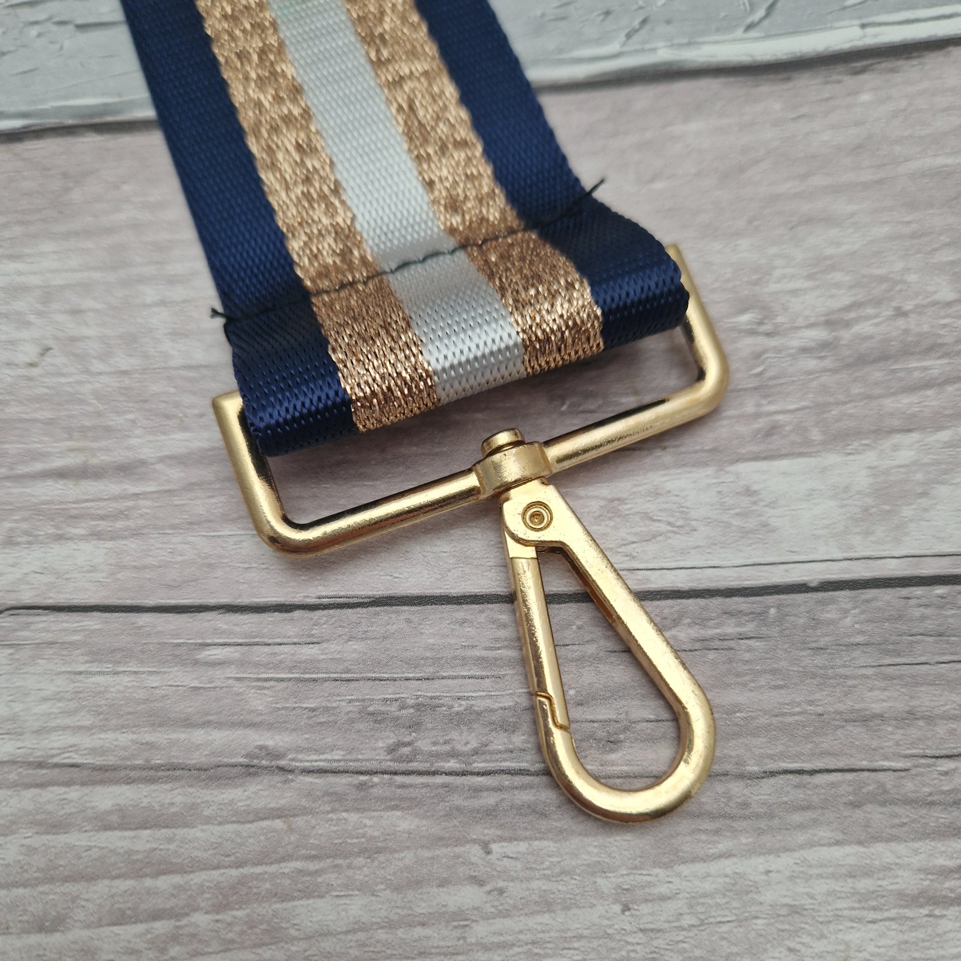 Bag strap with Navy, white and metallic bronze stripe.