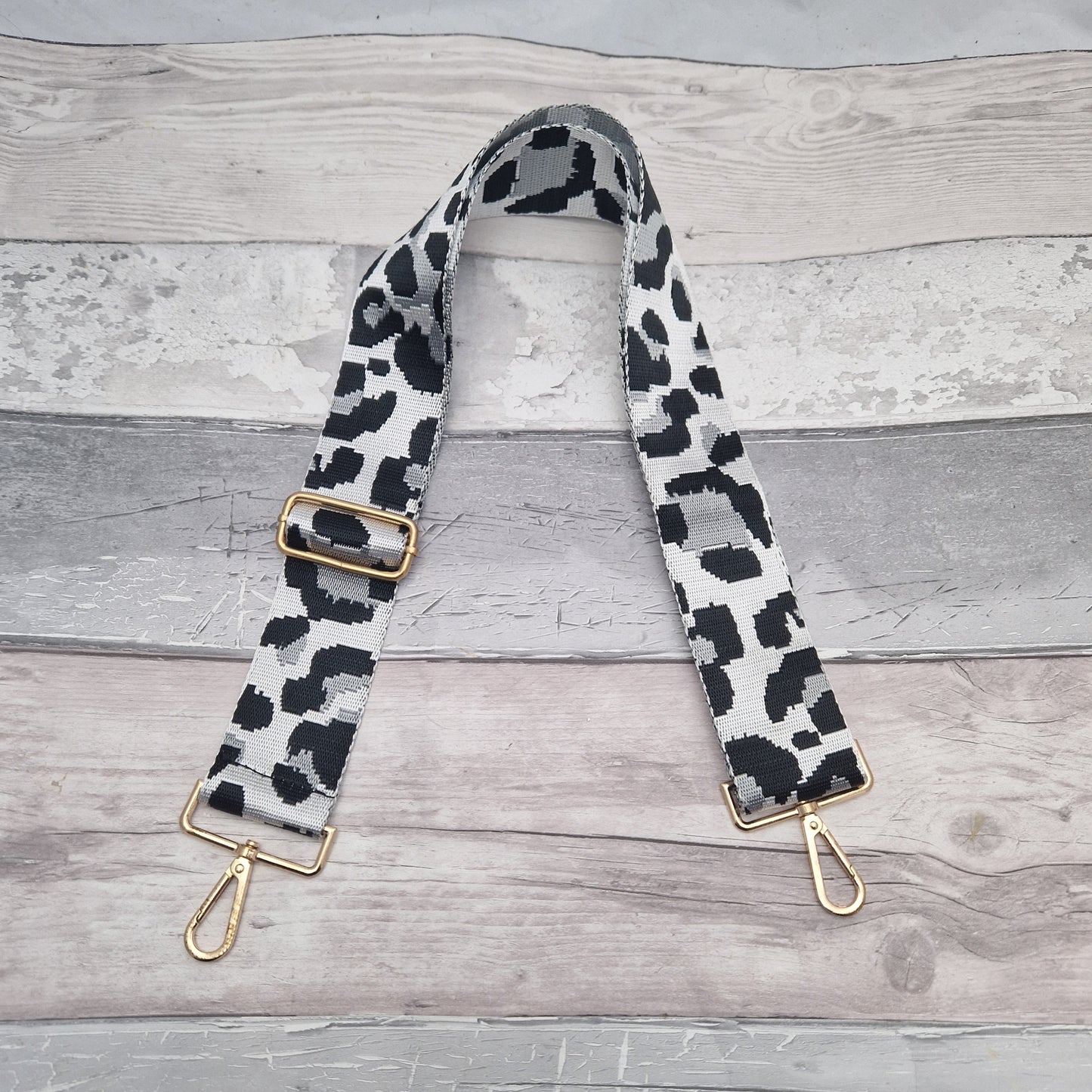 Leopard print bag strap in white, black and silver with gold metalwork