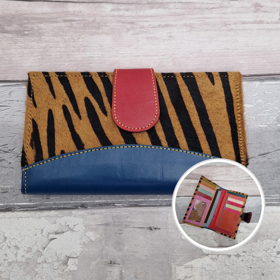 All leather wallet style purse made from multi-coloured pieces with a blue front panel and textured tiger print cover.