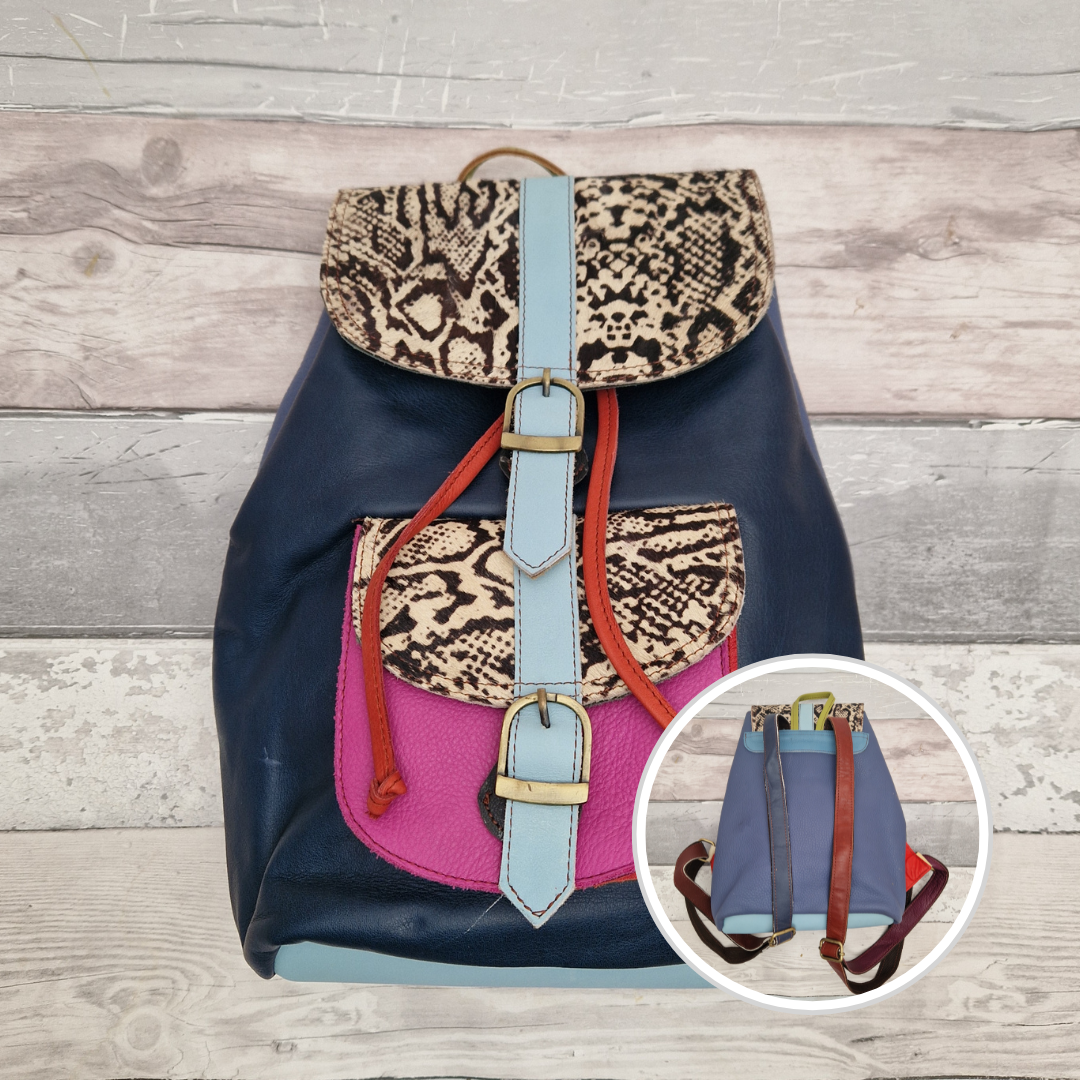 Navy blue Leather back pack with textured panels in black and white snake print.