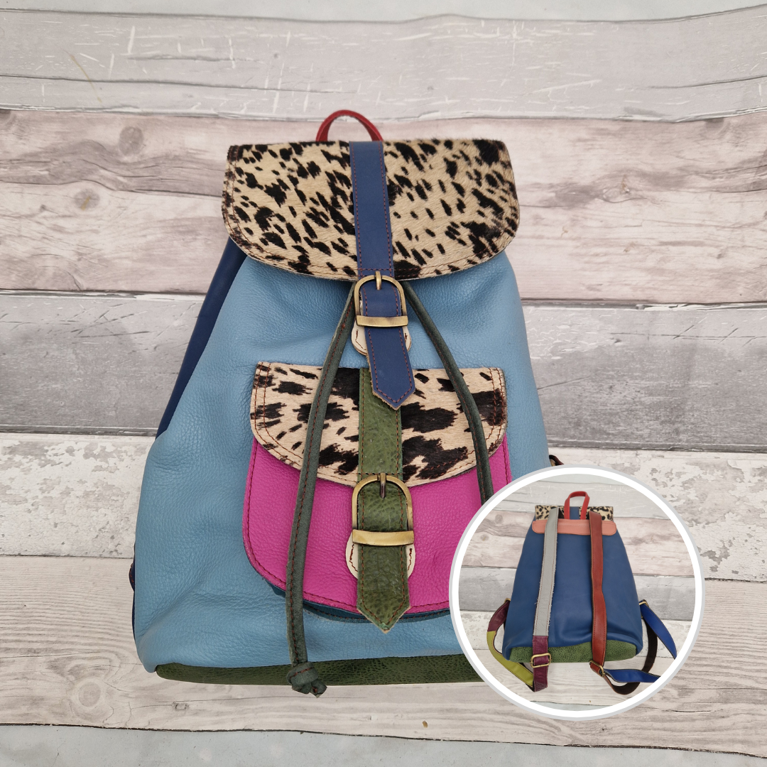 Multicolored backpack made from leather with front pocket and magnetic buckle closers. Pink and blue colours with textured pony print panels.