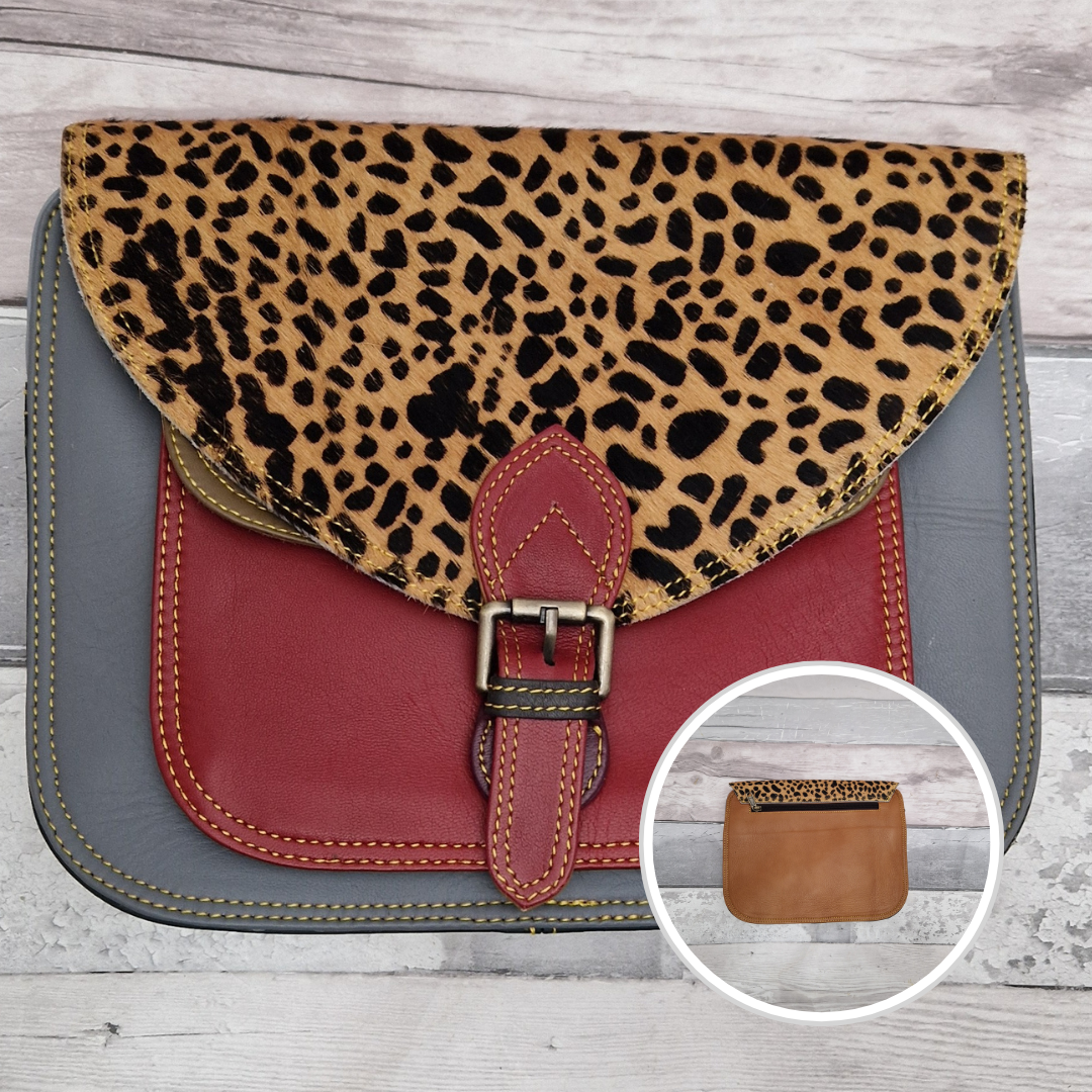Large Saddlebag style leather crossbody bag. Multicoloured panels of stone blue and red finished with a spot print textured flap.
