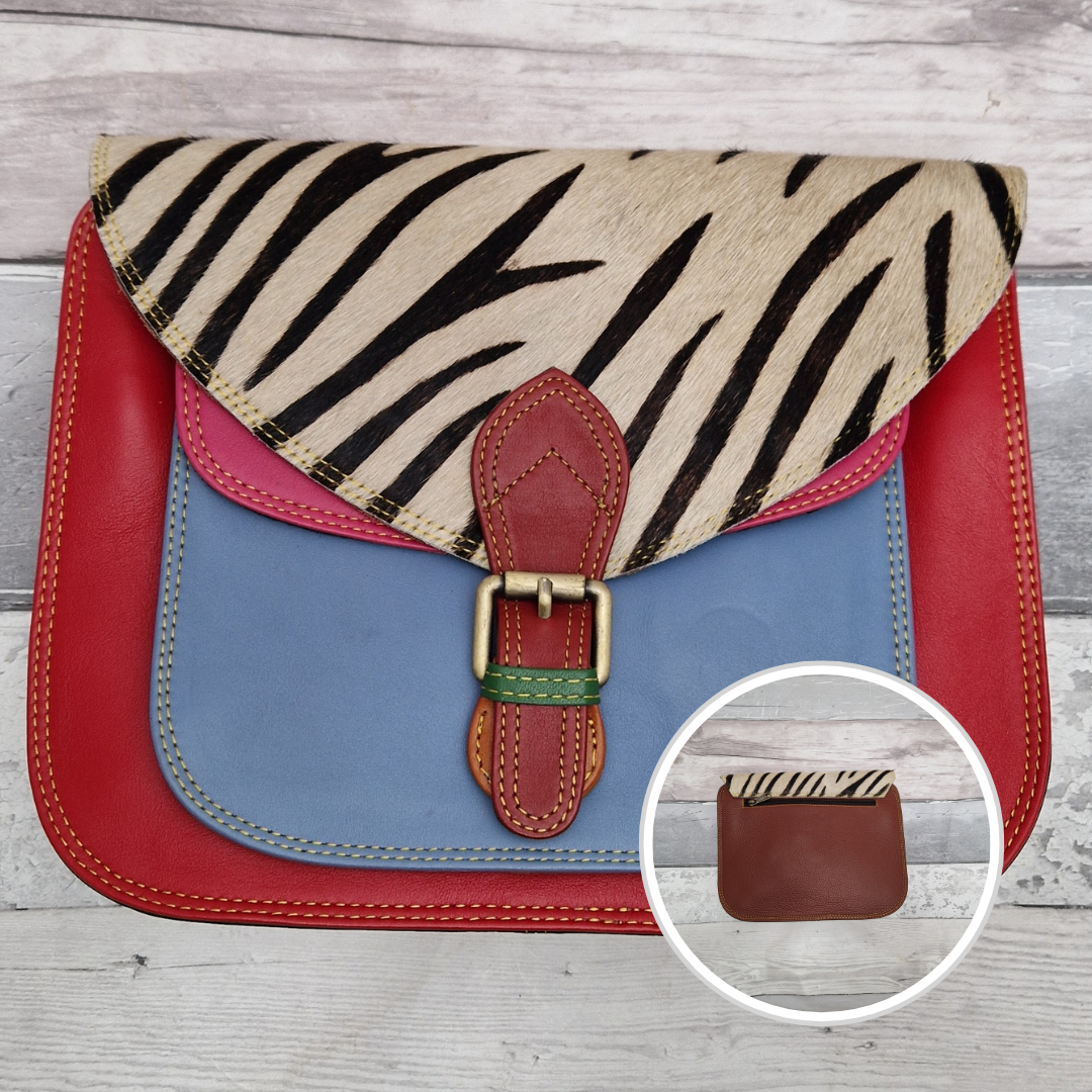 Large Saddlebag style leather crossbody bag. Multicoloured panels of blue, pink and red finished with a zebra print textured flap.