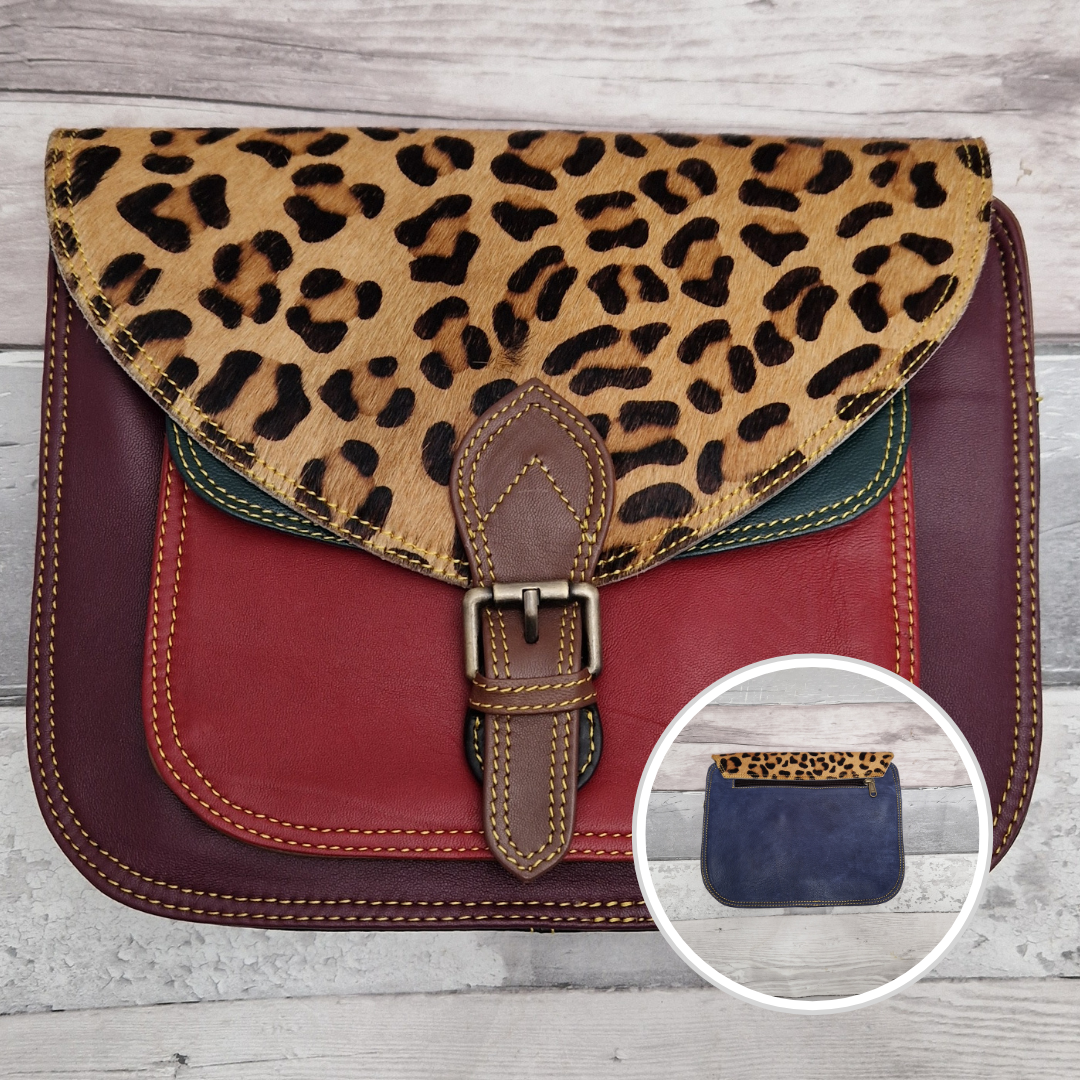 Large Saddlebag style leather crossbody bag. Multicoloured panels of cherry, dark green and red finished with a jaguar print textured flap.