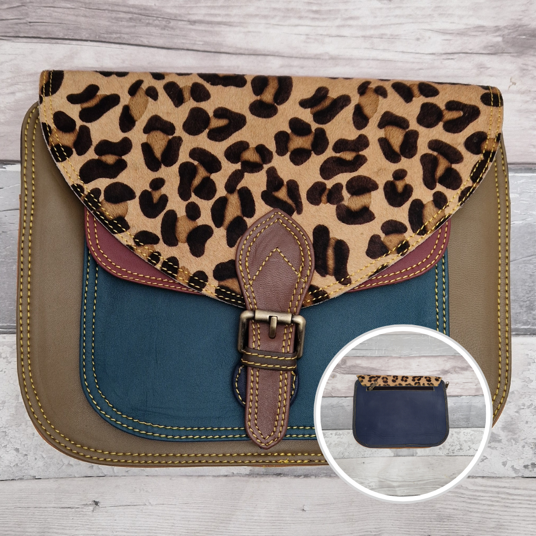 Large Saddlebag style leather crossbody bag. Multicoloured panels of olive green, turquoise and red finished with a leopard print textured flap.