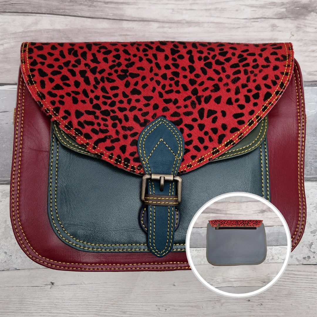 Large Saddlebag style leather crossbody bag. Multicoloured panels of green and red finished with a red lynx print textured flap.