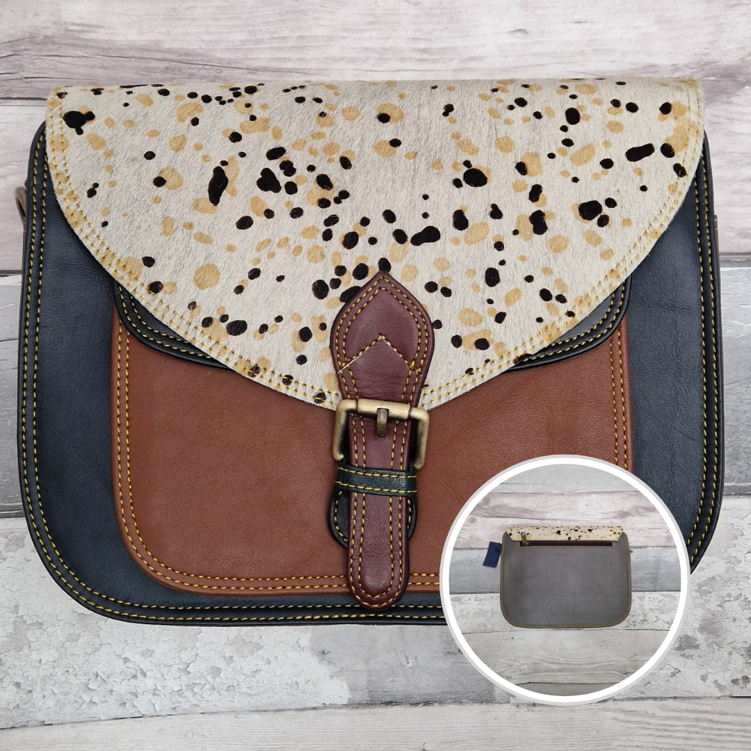 Large Saddlebag style leather crossbody bag. Multicoloured panels of navy and tan finished with a spot print textured flap.