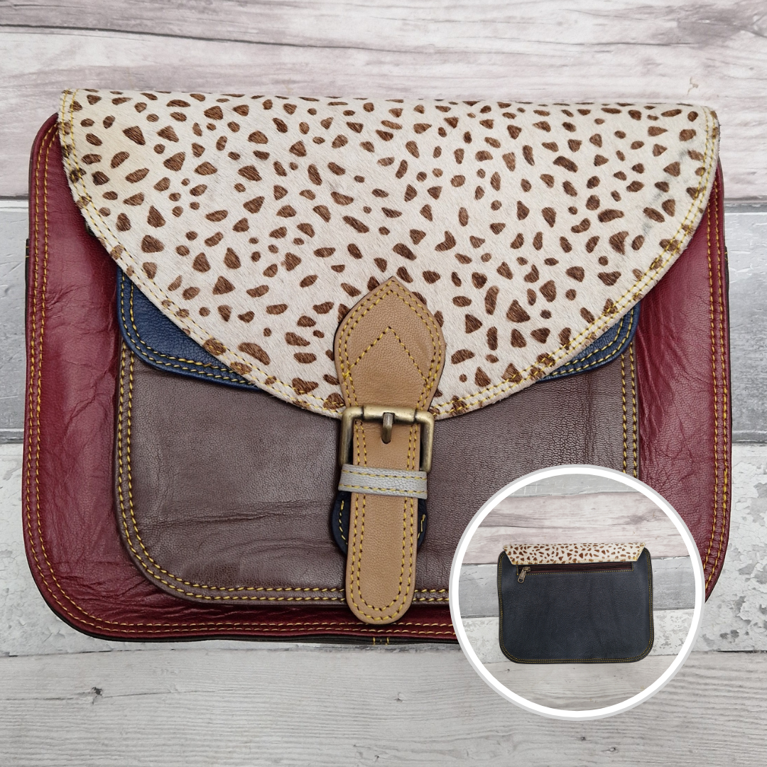 Large Saddlebag style leather crossbody bag. Multicoloured panels of dark red, brown and navy finished with a lynx print textured flap.