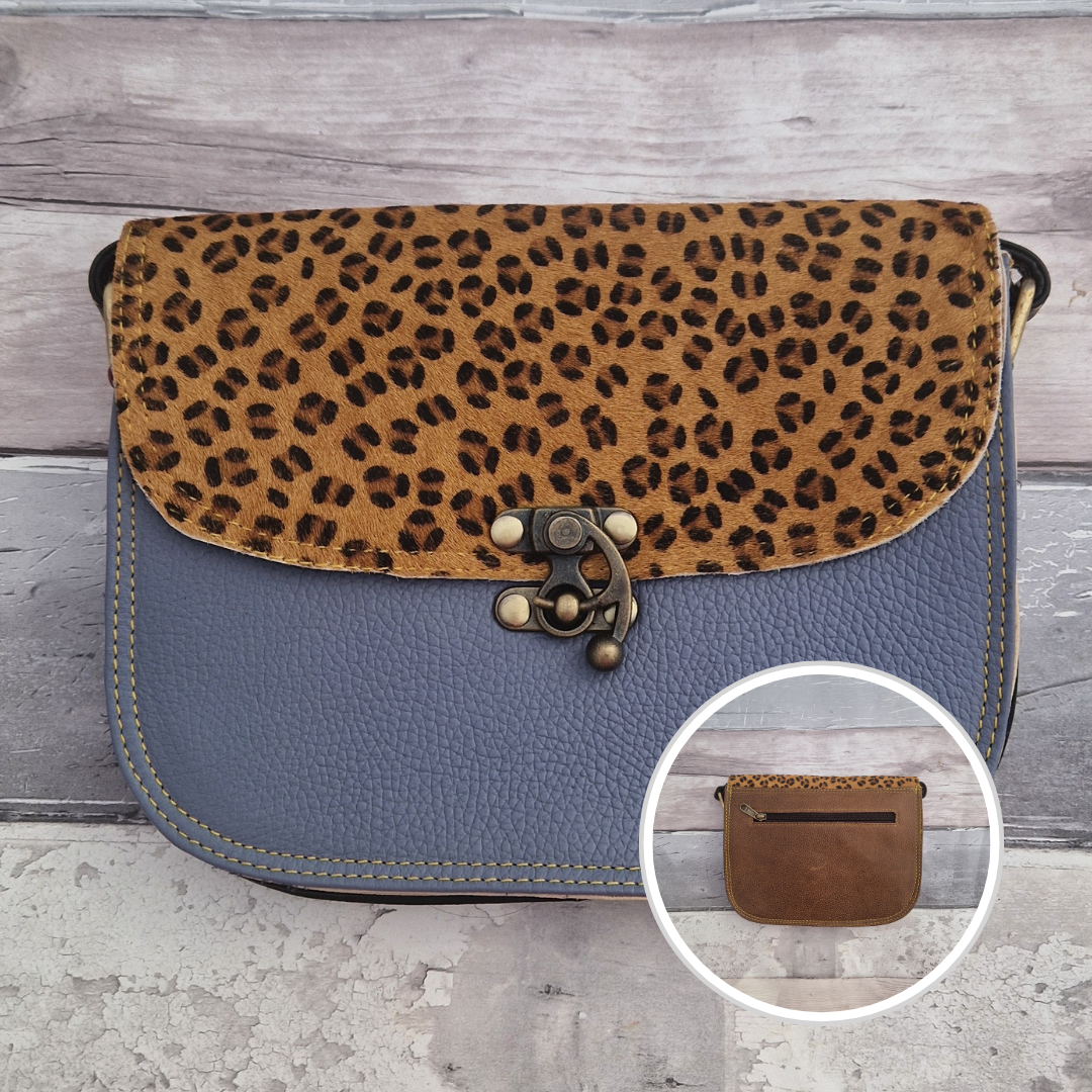 All leather blue coloured bag with a textured panel of leopard animal print. A brass swivel clasp secured the bag at the front.