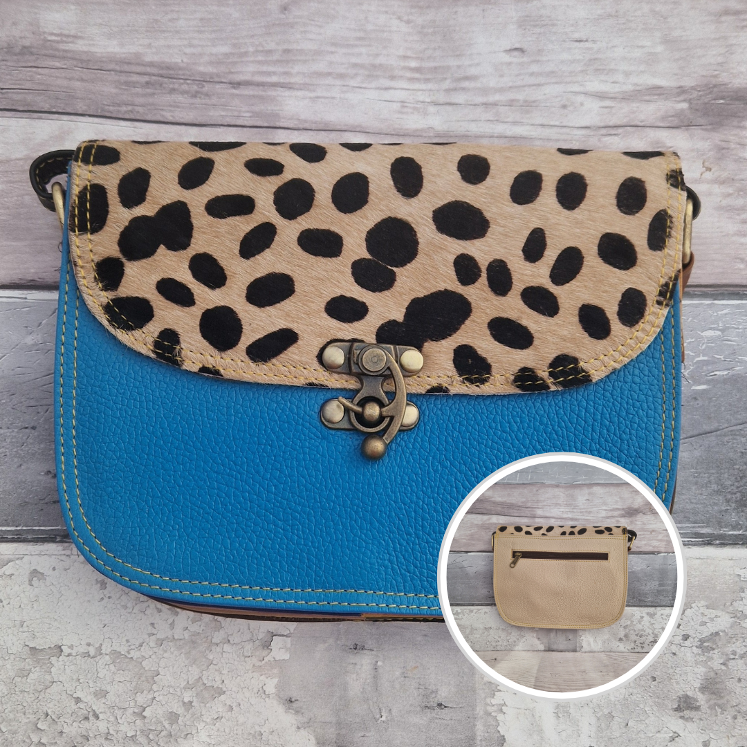All leather blue coloured bag with a textured panel of spotty animal print. A brass swivel clasp secured the bag at the front.
