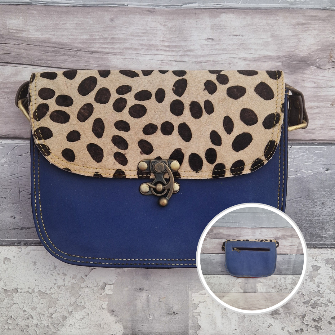 All leather Royal blue coloured bag with a textured panel of spotty animal print. A brass swivel clasp secured the bag at the front.