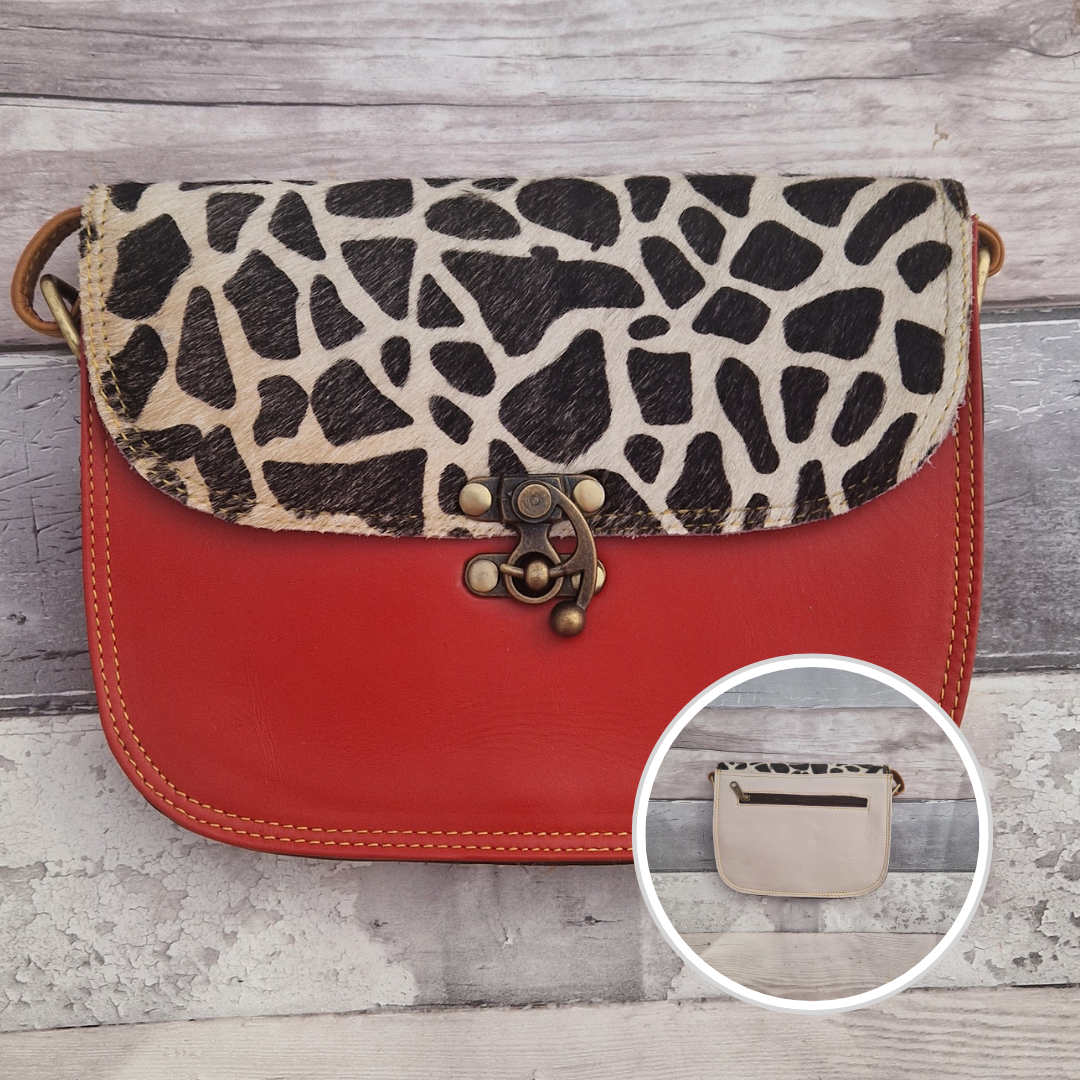All leather red coloured bag with a textured panel of giraffe animal print. A brass swivel clasp secured the bag at the front.