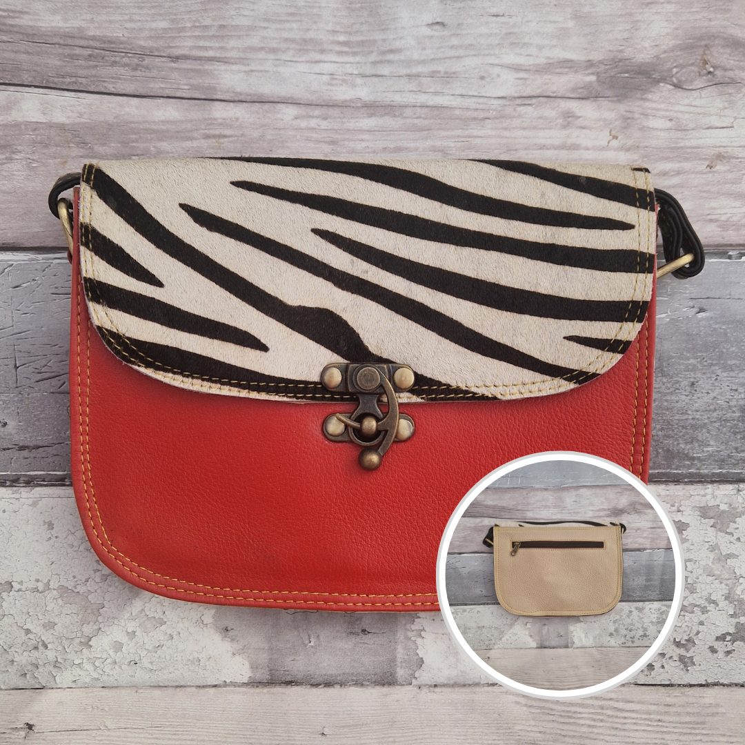 All leather red coloured bag with a textured panel of zebra animal print. A brass swivel clasp secured the bag at the front.