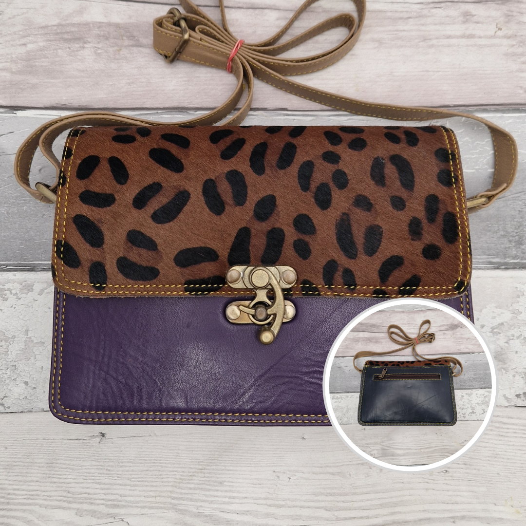 All leather purple coloured bag with a textured panel of leopard animal print. A brass swivel clasp secured the bag at the front.