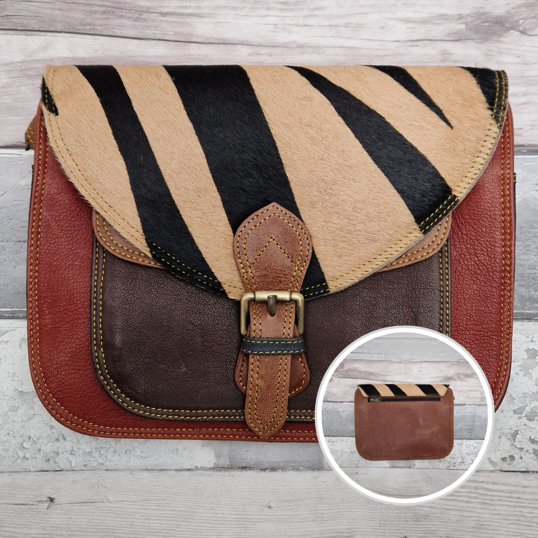 Large Saddlebag style leather crossbody bag. Multicoloured panels of rust red, brown and tan finished with a tiger print textured flap.