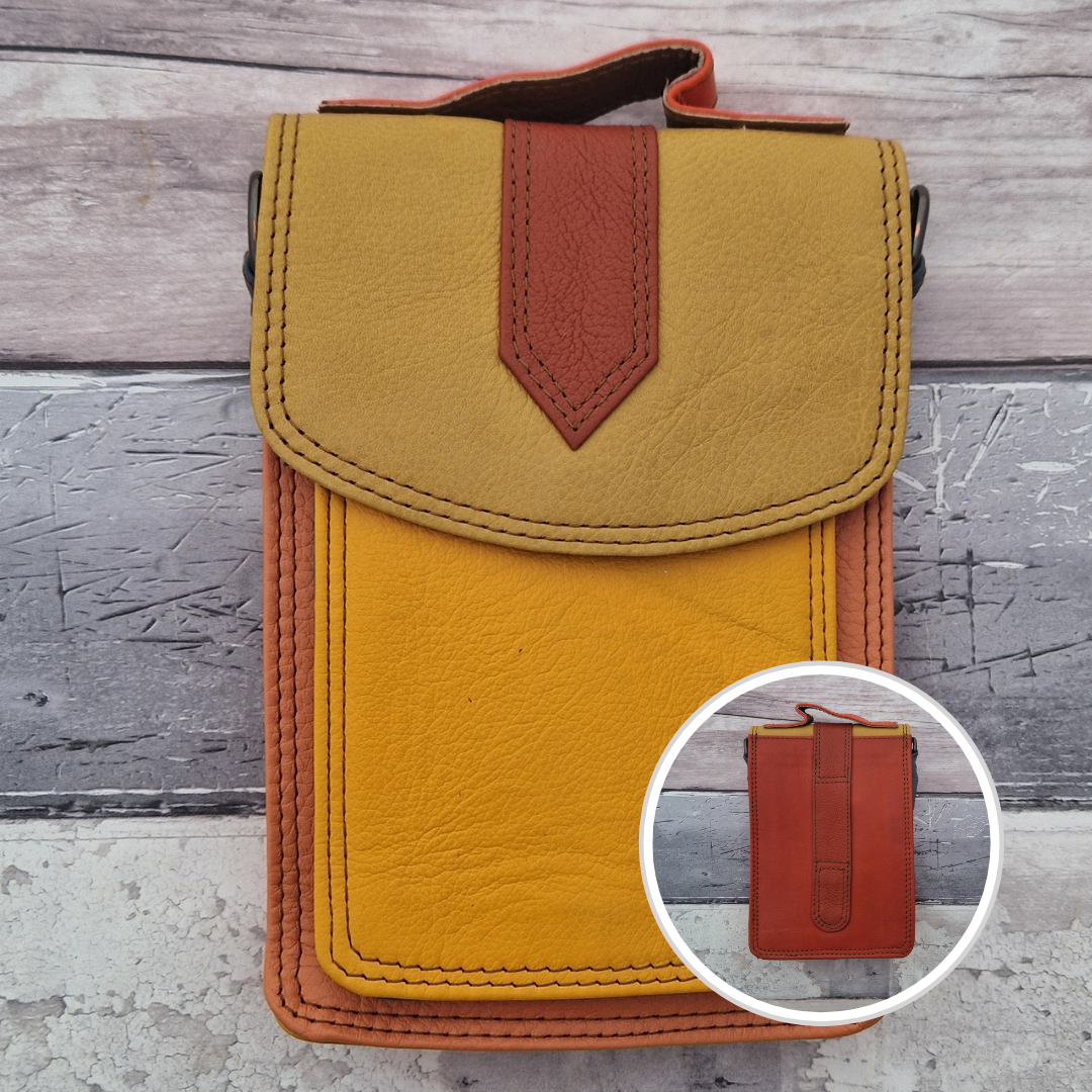 All leather crossbody bag with carry handle made up in a variety of brightly coloured panels.