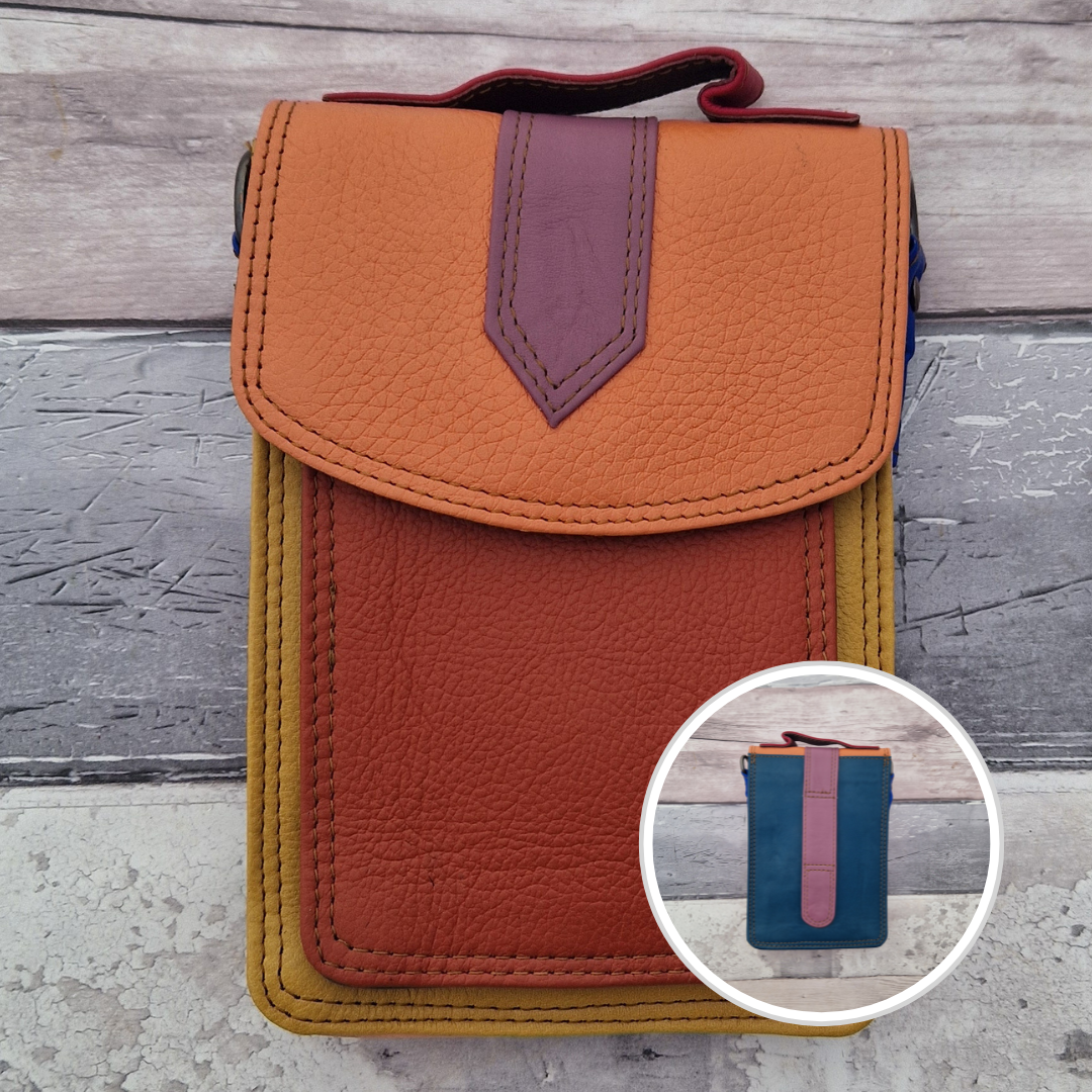All leather crossbody bag with carry handle made up in a variety of brightly coloured panels.