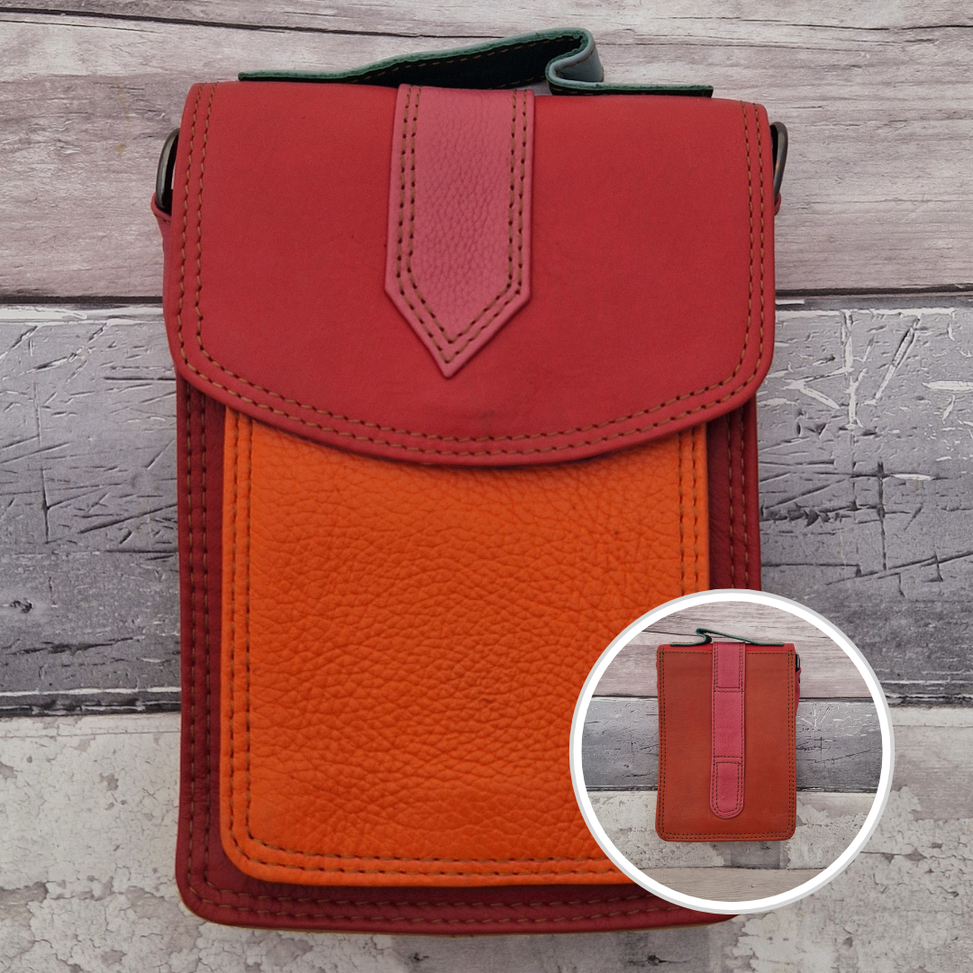All leather crossbody bag with carry handle made up in a variety of brightly coloured panels.