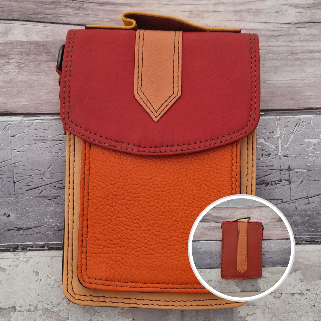 All leather crossbody bag with carry handle made up in a variety of brightly coloured panels.