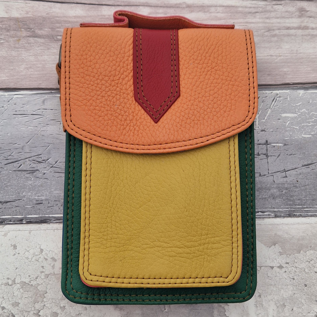 All leather crossbody bag with carry handle made up in a variety of brightly coloured panels.