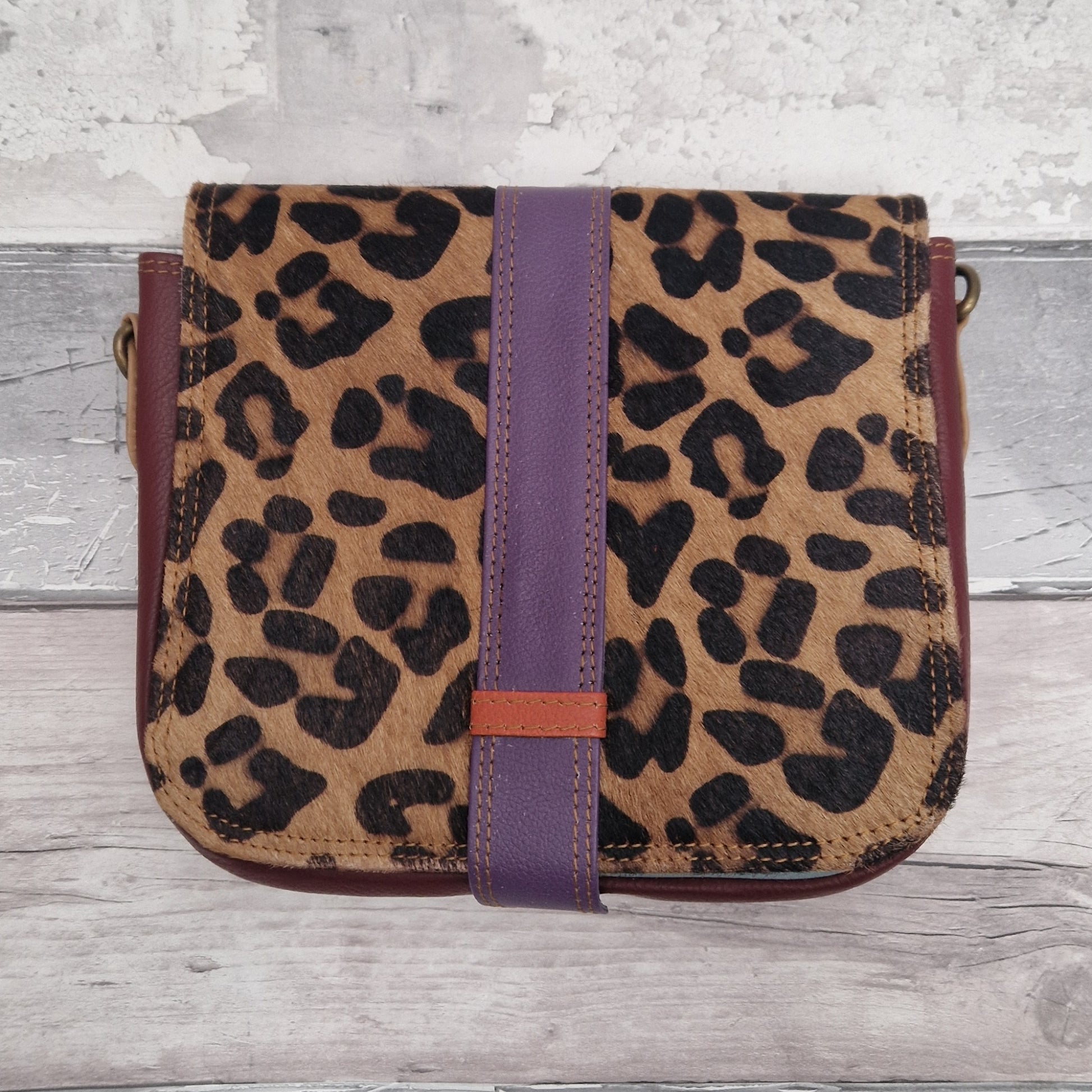All leather bag with a textured leopard print front panel.