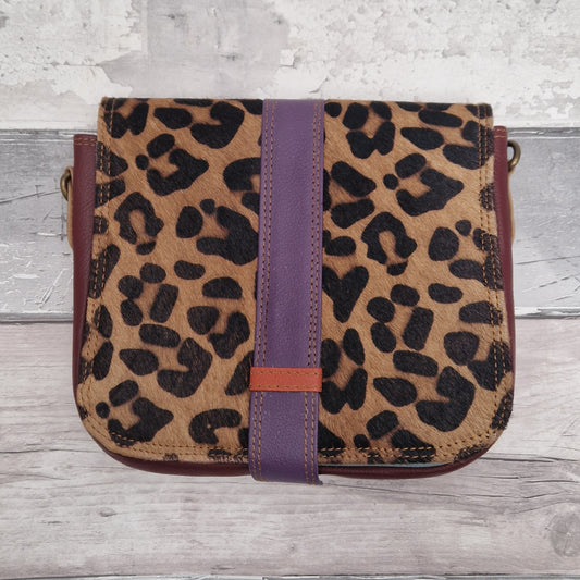 All leather bag with a textured leopard print front panel.