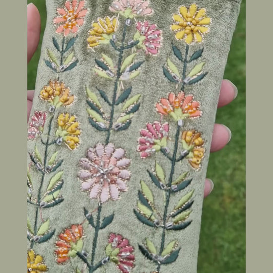 Video of green velvet gerbera bloom glasses case.