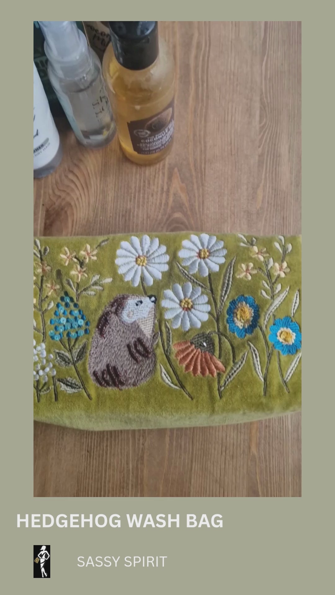 Video depicting velvet mustard coloured wash bag decorated with embroidered flower garden design being loaded with toiletries.