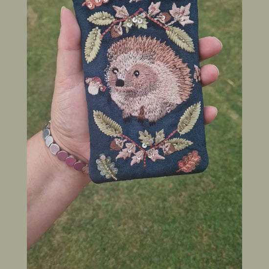 Navy velvet glasses case decorated with an embroidered Hedgehog woodland scene. Finished with beads and sequins.