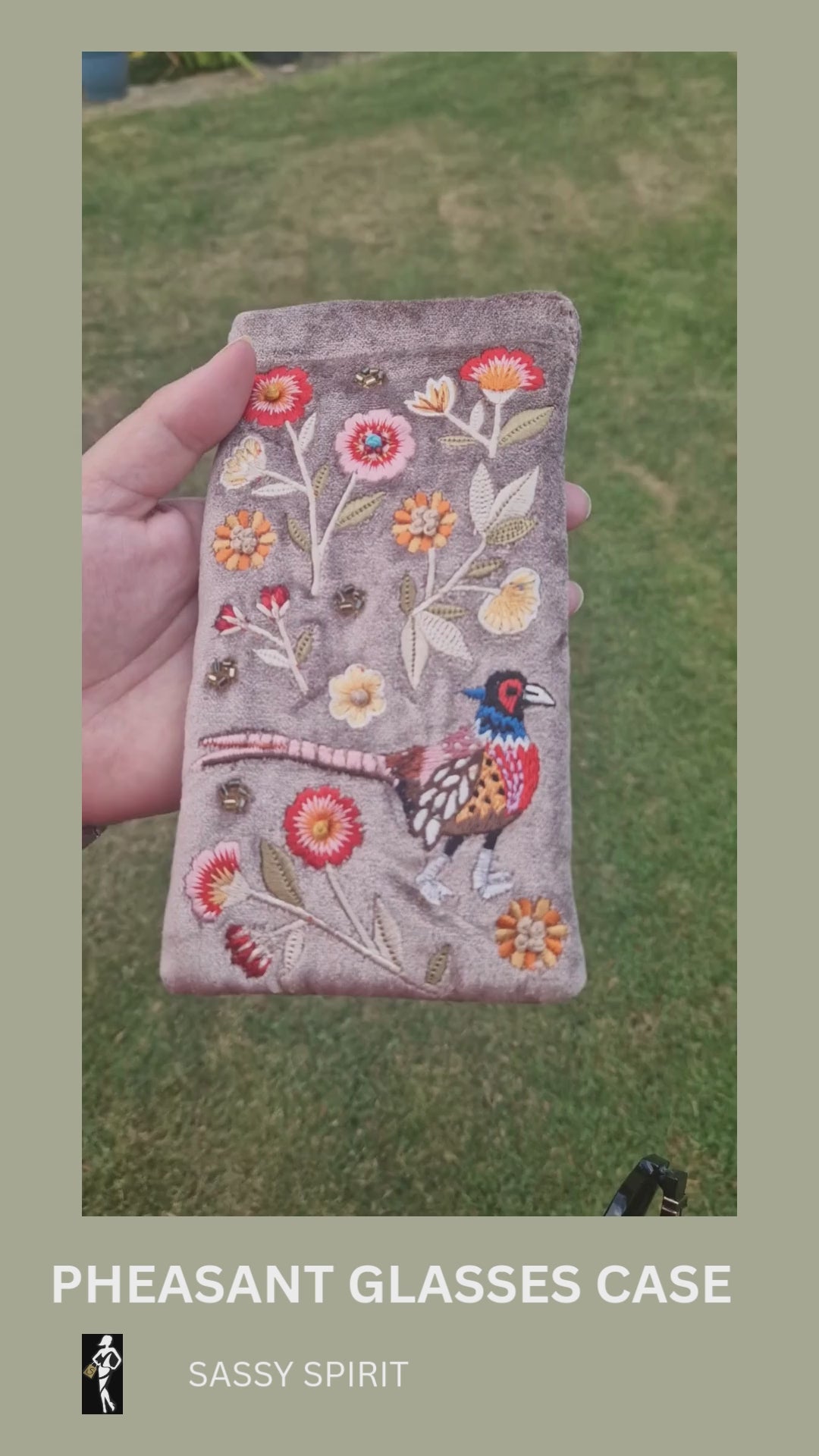Fawn coloured velvet glasses case decorated with an embroidered scene featuring a Pheasant in a flower garden. The scene is finished with beads and sequins.