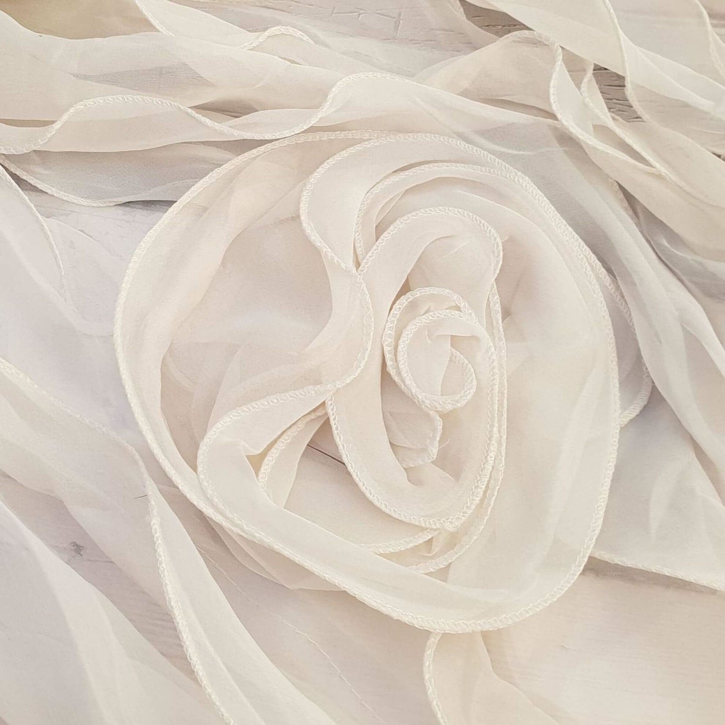 Photo of a cream scarf with rose feature