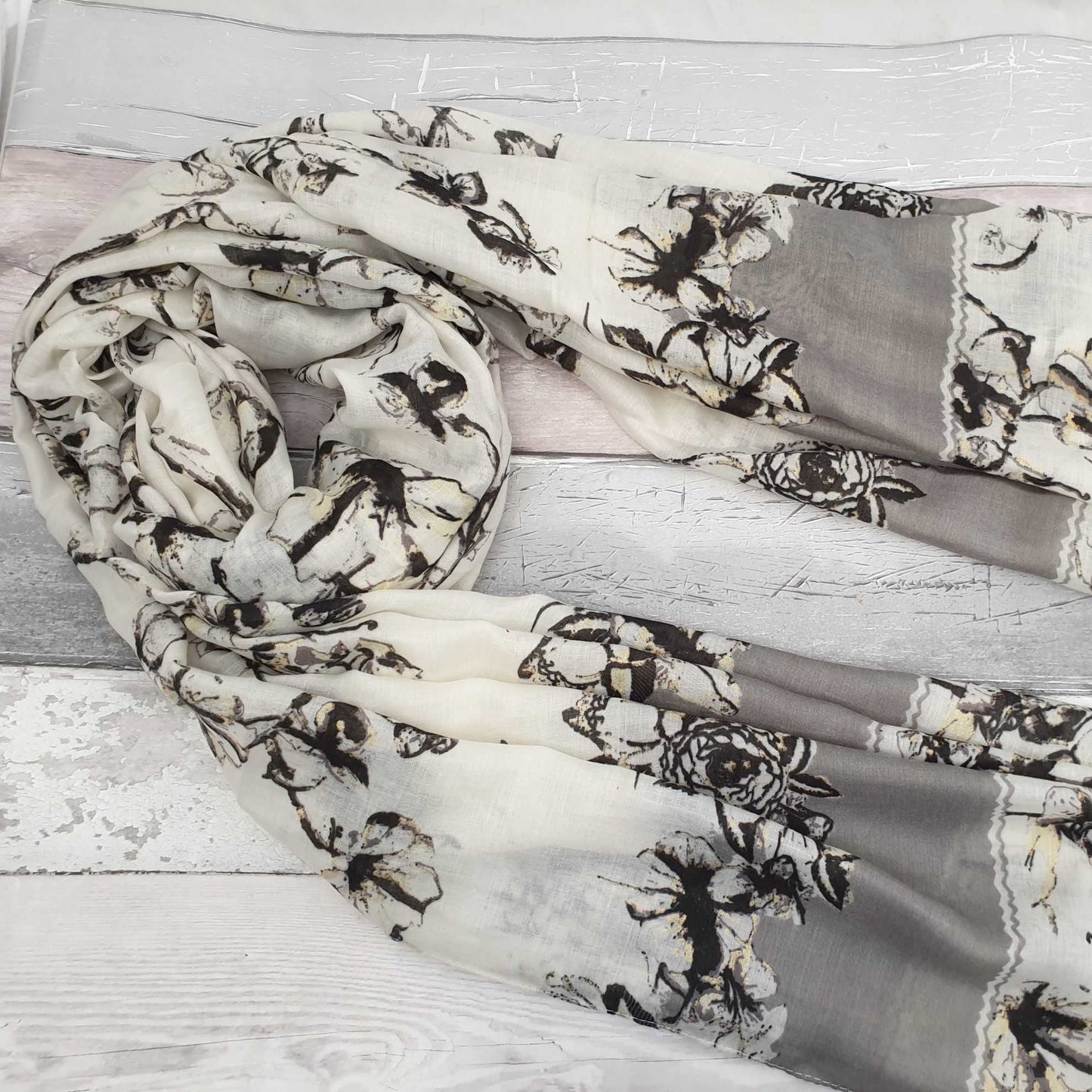 Photo of a Black and White Floral scarf with gold detailing