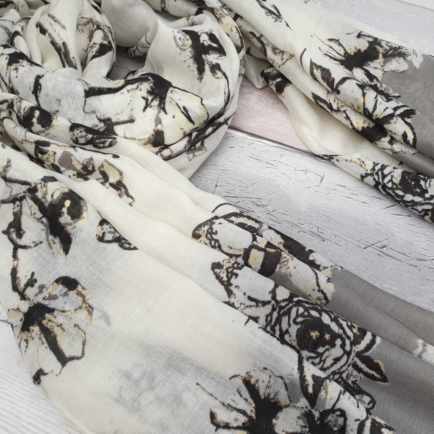 Photo of a Black and White Floral scarf with gold detailing