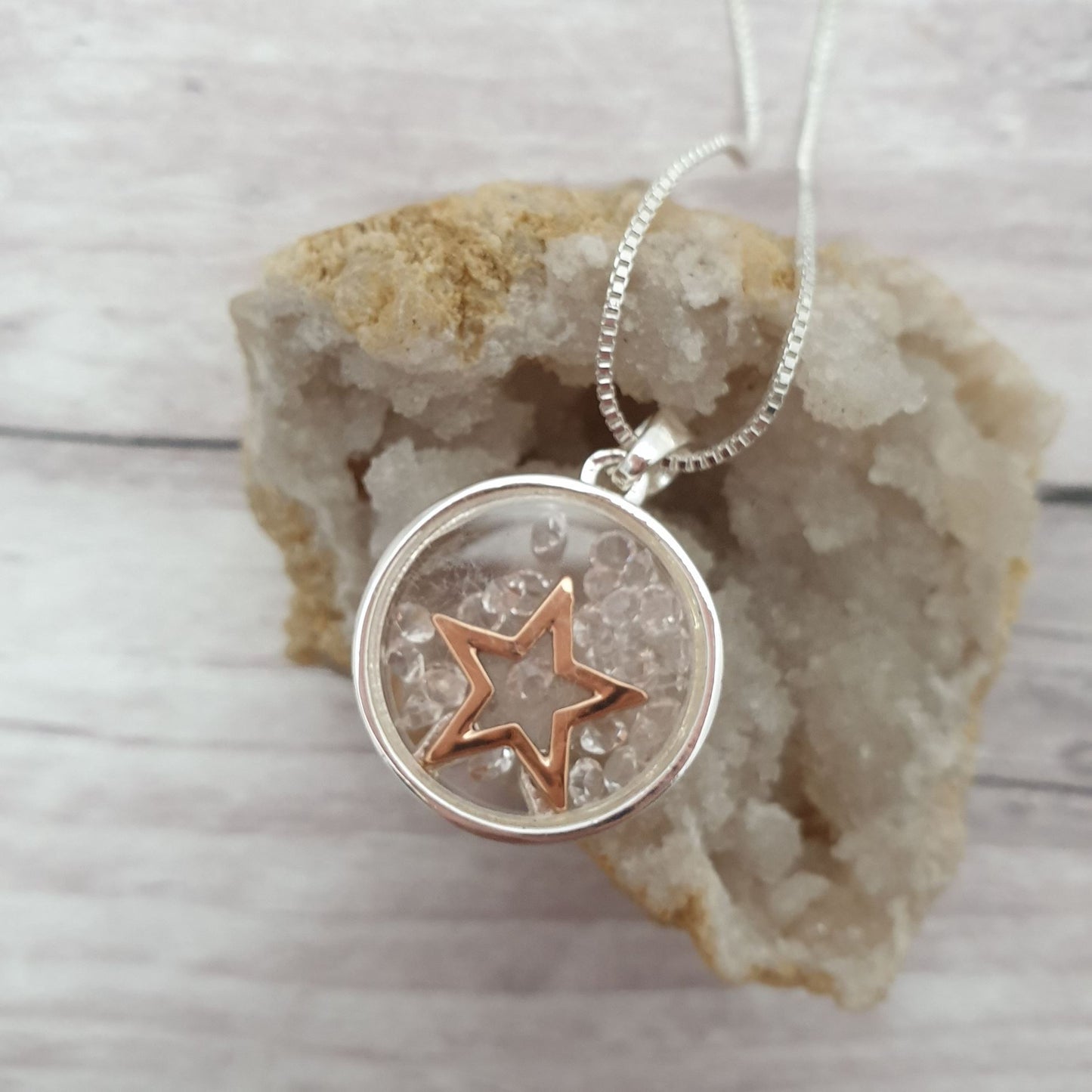 Photo of a Silver circular pendant decorated with a Rose Gold Star and diamante Crystals