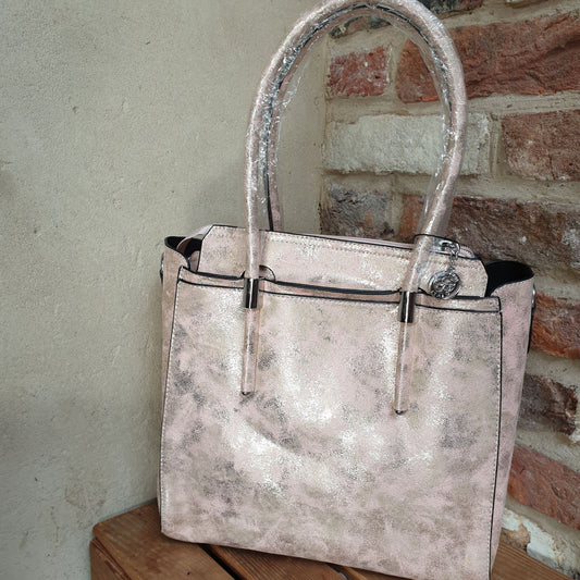 Photo of a blush pink bag with a metallic rose gold finish