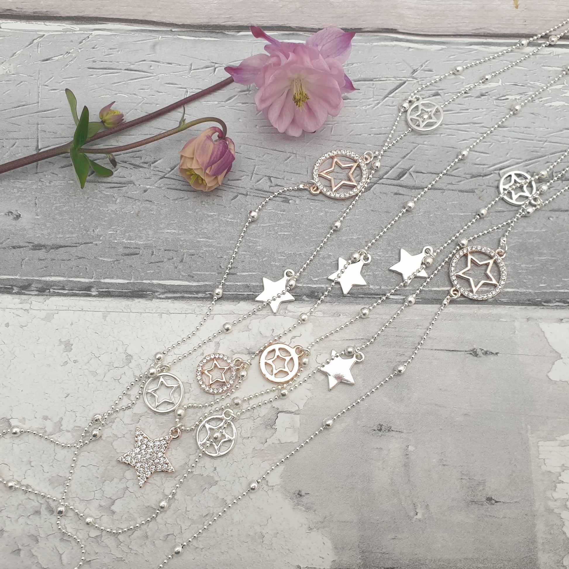 Photo of a rose gold and silver long length necklace decorated with stars