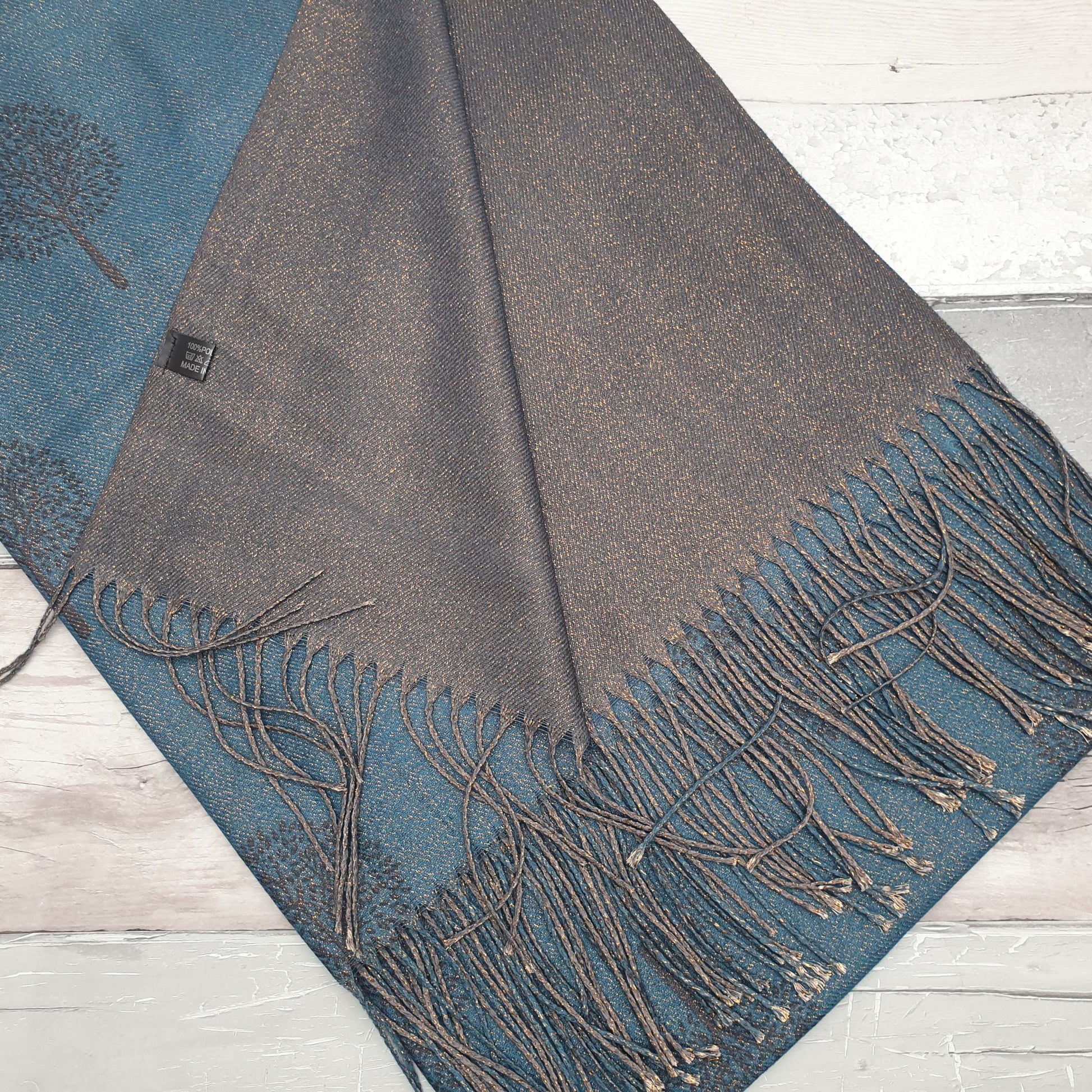 Photo of a Teal Blue scarf featuring the tree of life with a rose gold sheen