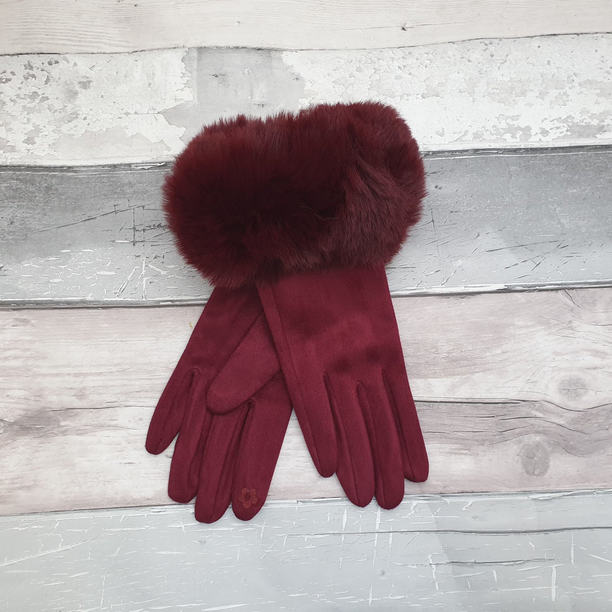 Photo of a pair of rich red wine coloured gloves with a faux fur trim