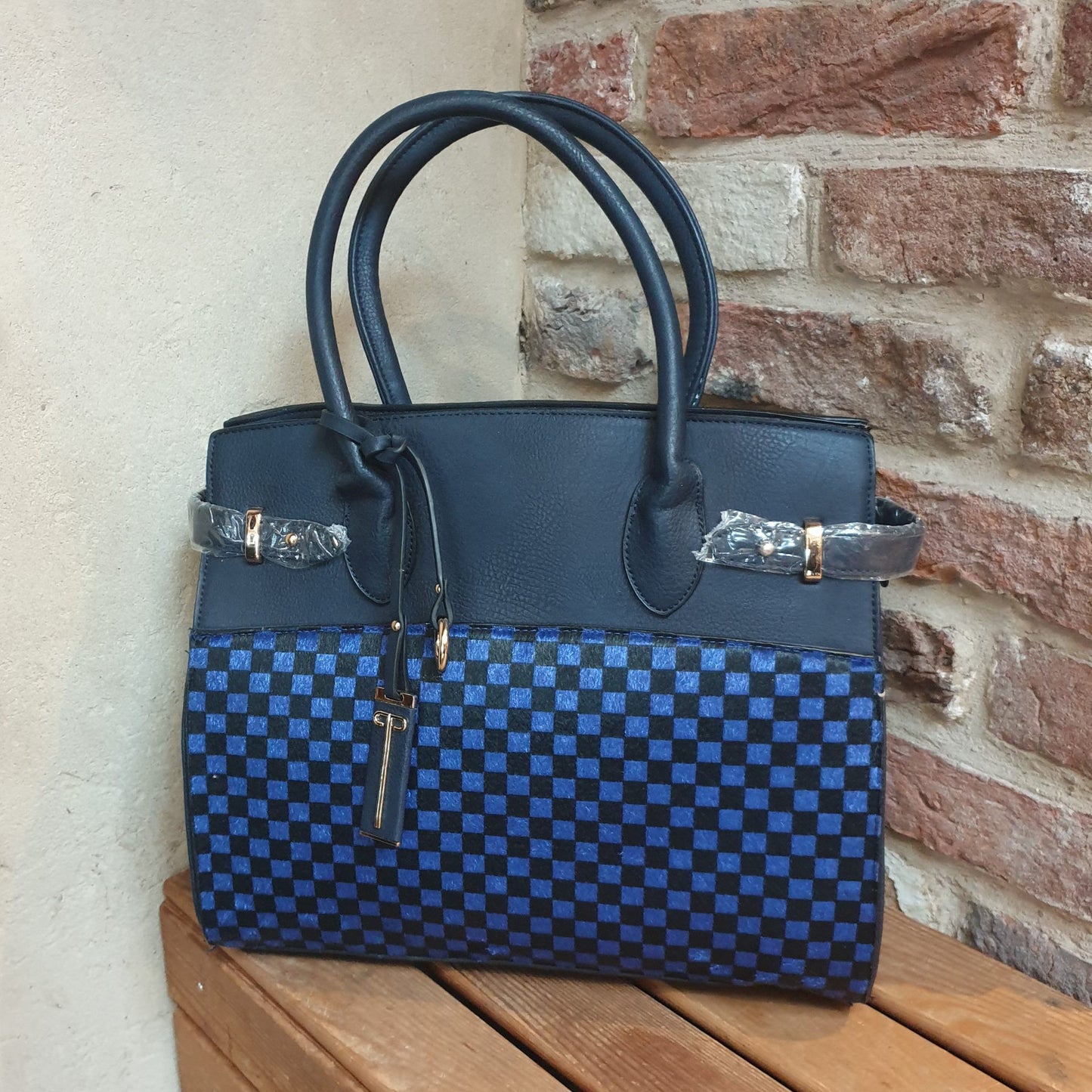 Photo of a Navy Bag with a checked front panel in royal blue and Black