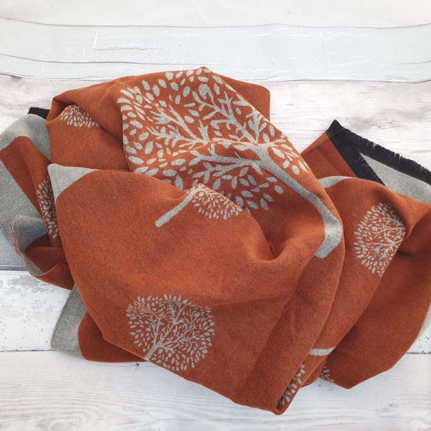 Photo of a Burnet Orange coloured scarf with a Mulberry Tree Pattern