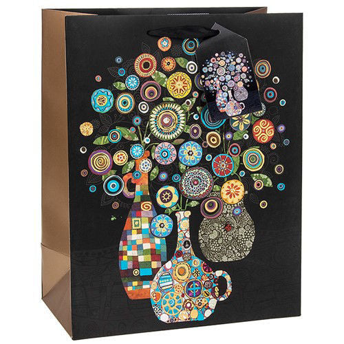Photo of a Black Gift Bag with a brightly colored vase of flowers