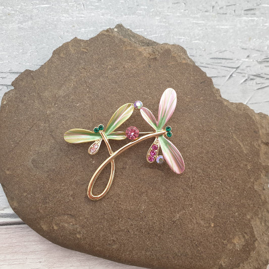 Photo of a pair of dancing dragonflies captured as a brooch
