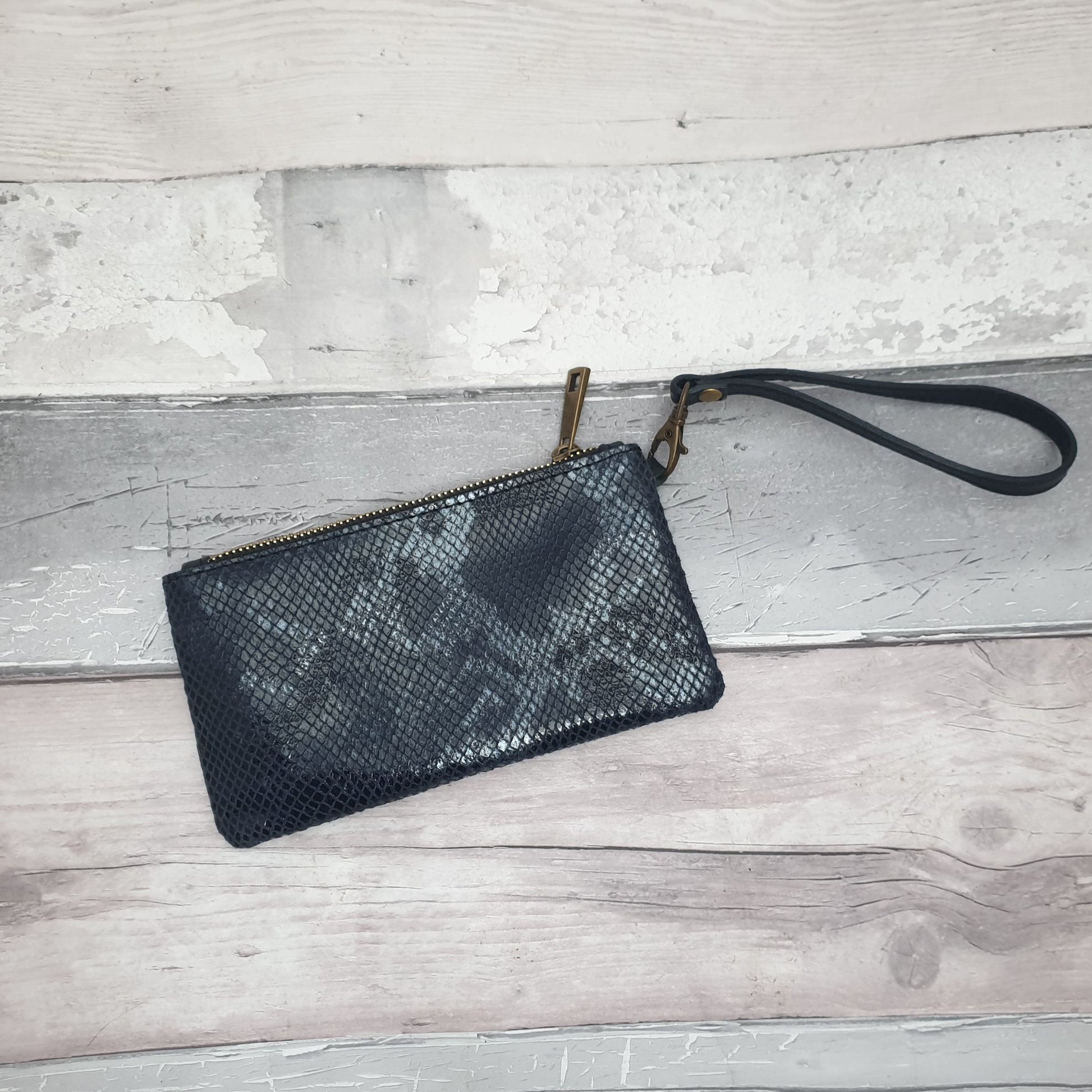 Photo of a Navy and Grey Snake Print Leather clutch bag with detachable wrist strap