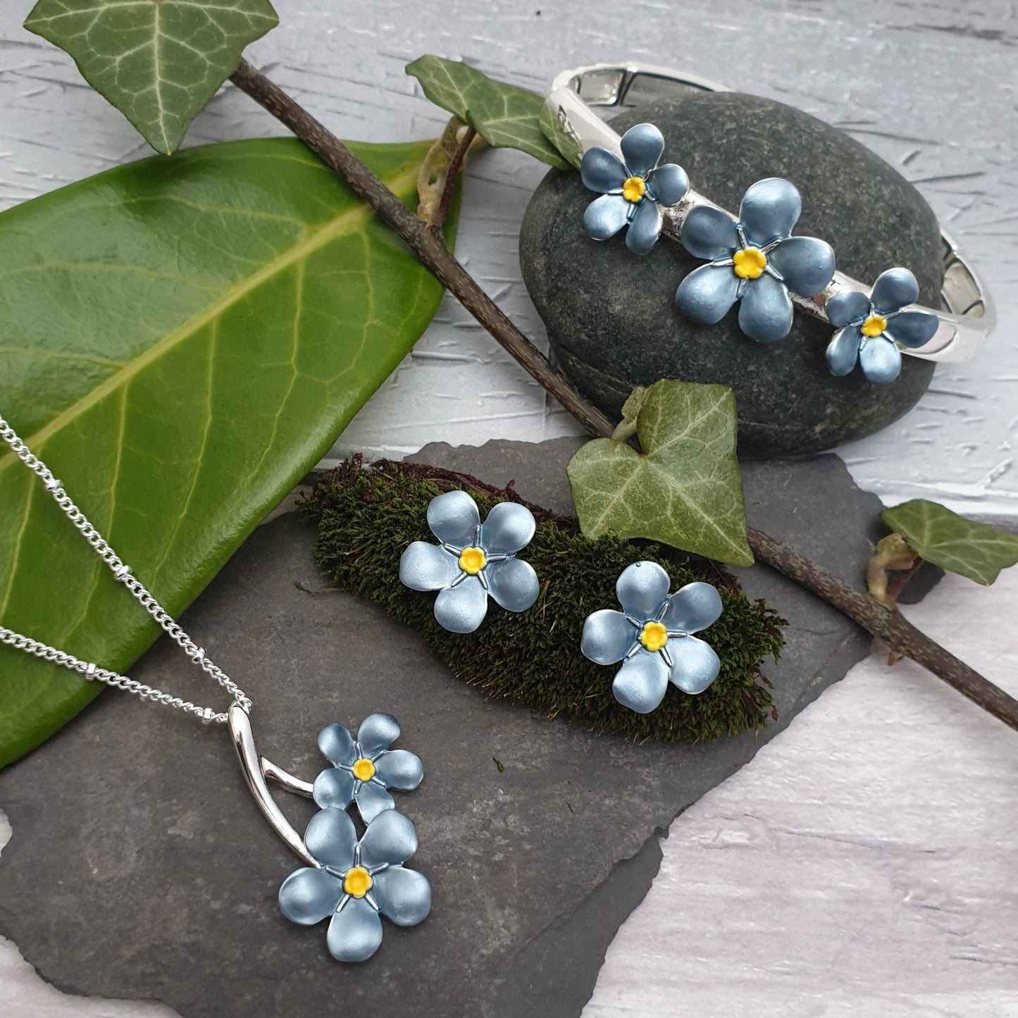 3 pieces of Forget-Me-Not themed jewellery; necklace, stud earrings and bracelet