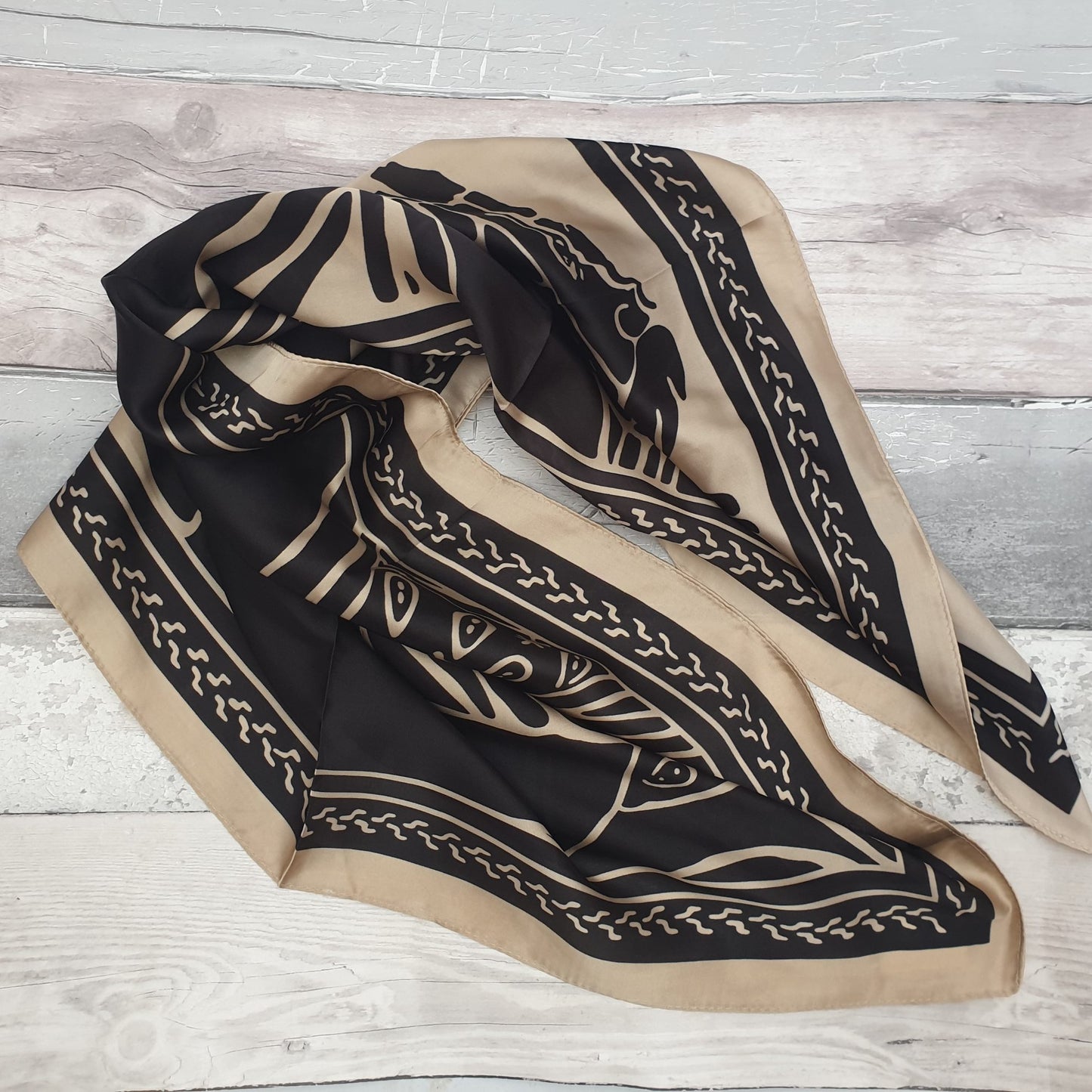 Coffee and black coloured scarf with a ancient horsemen print