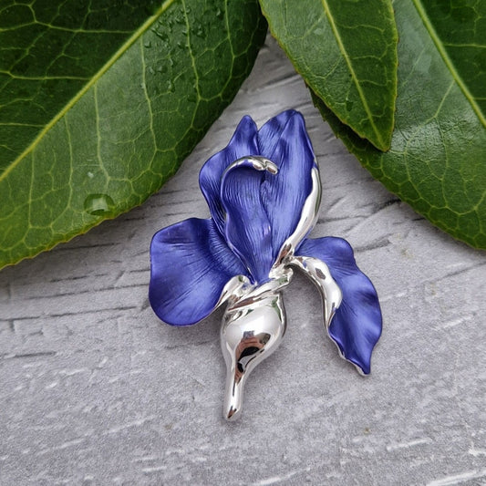 Very beautiful brooch in the shape of an Iris with brilliant blue petals and a silver stem.