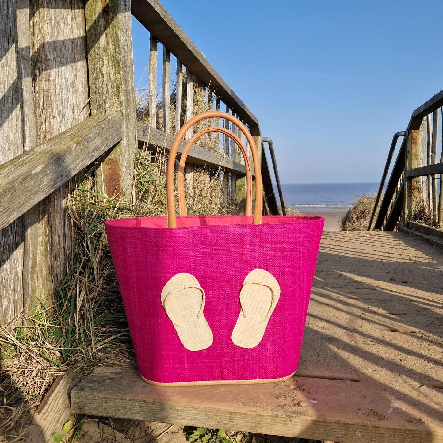 Hot Pink Raffia basket decorated with a pair of raffia flip flops